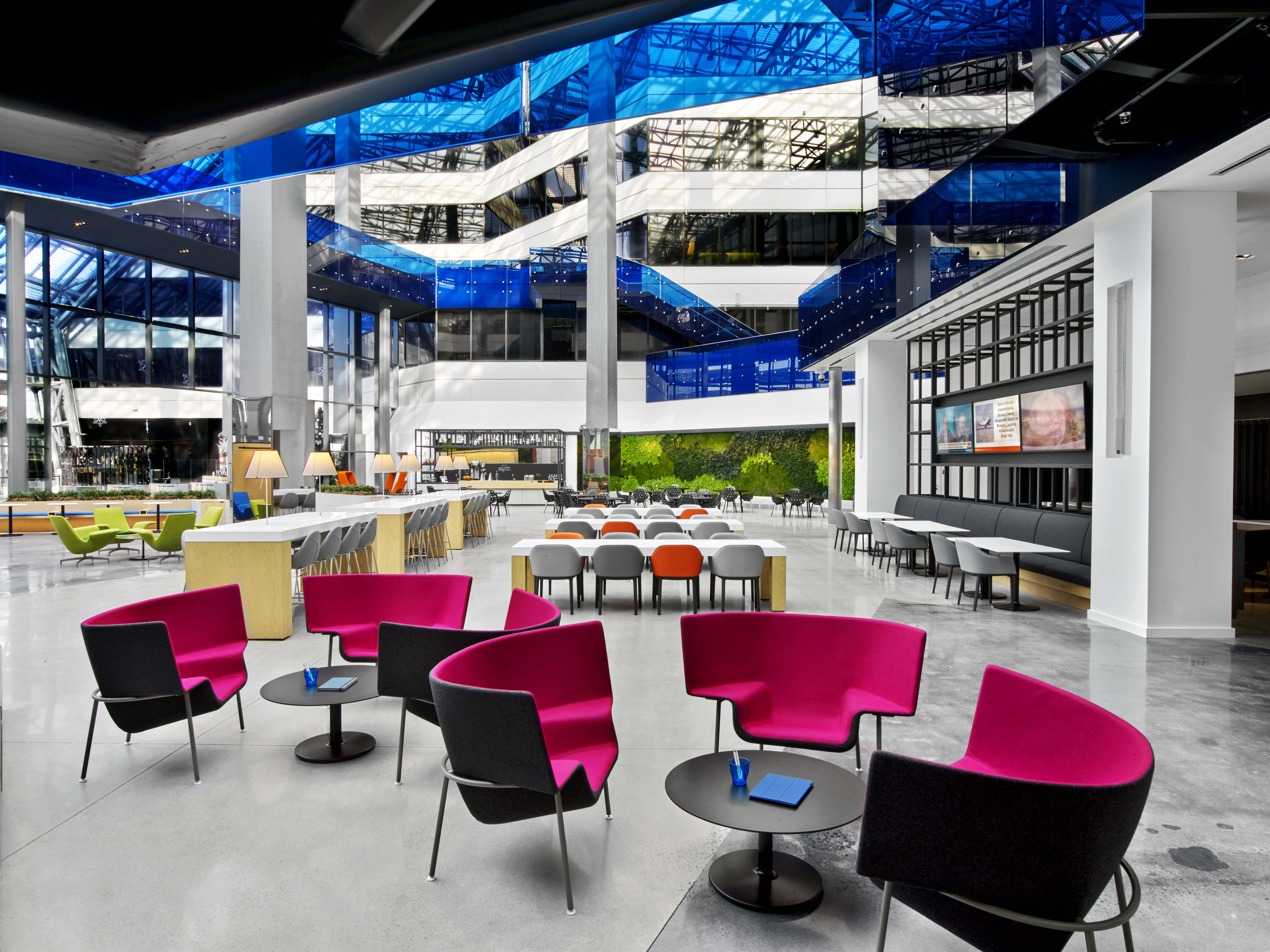 A wide-angle view of the atrium provides a glimpse at the variety of seating and design choices that can be used to elevate a space. Throughout the building, technology is integrated seamlessly into the design to support communication and productivity.