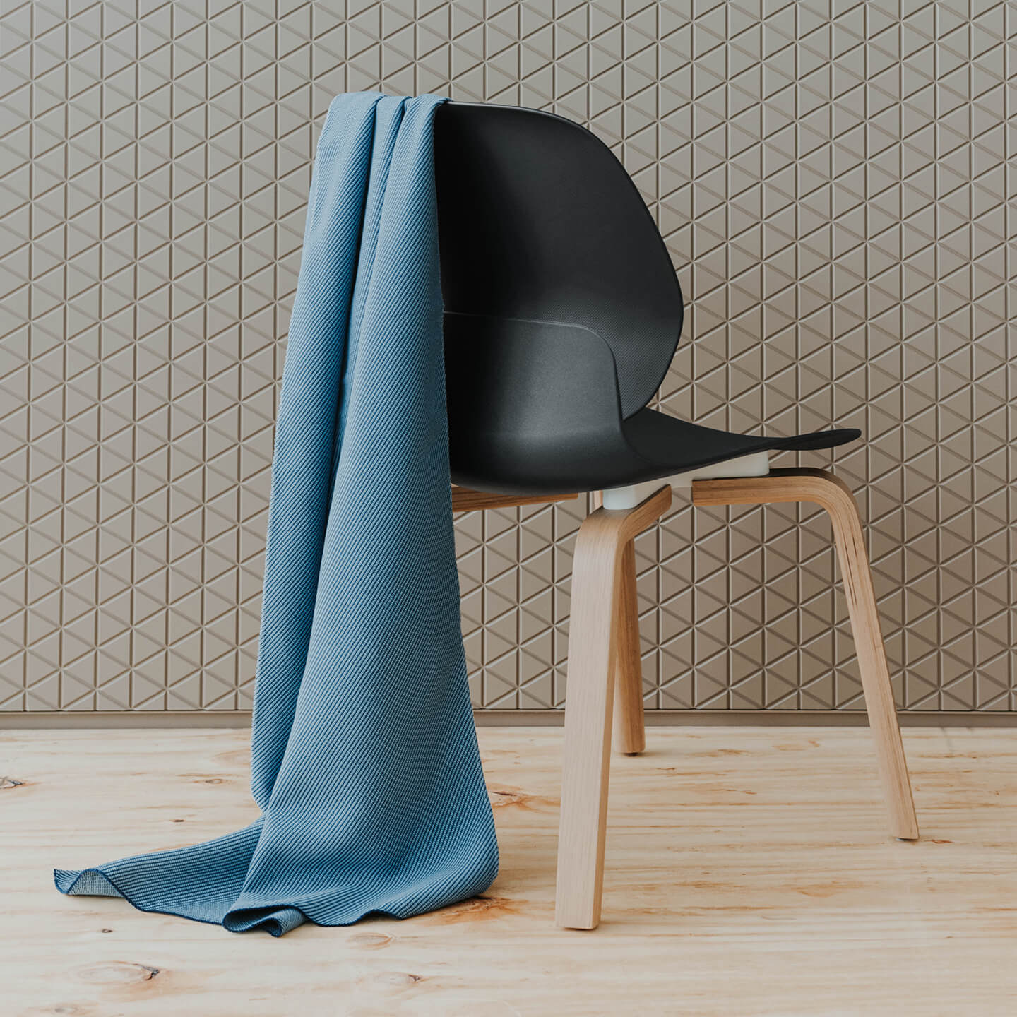 Haworth Oceanic fabric in blue handing over a Maari chair