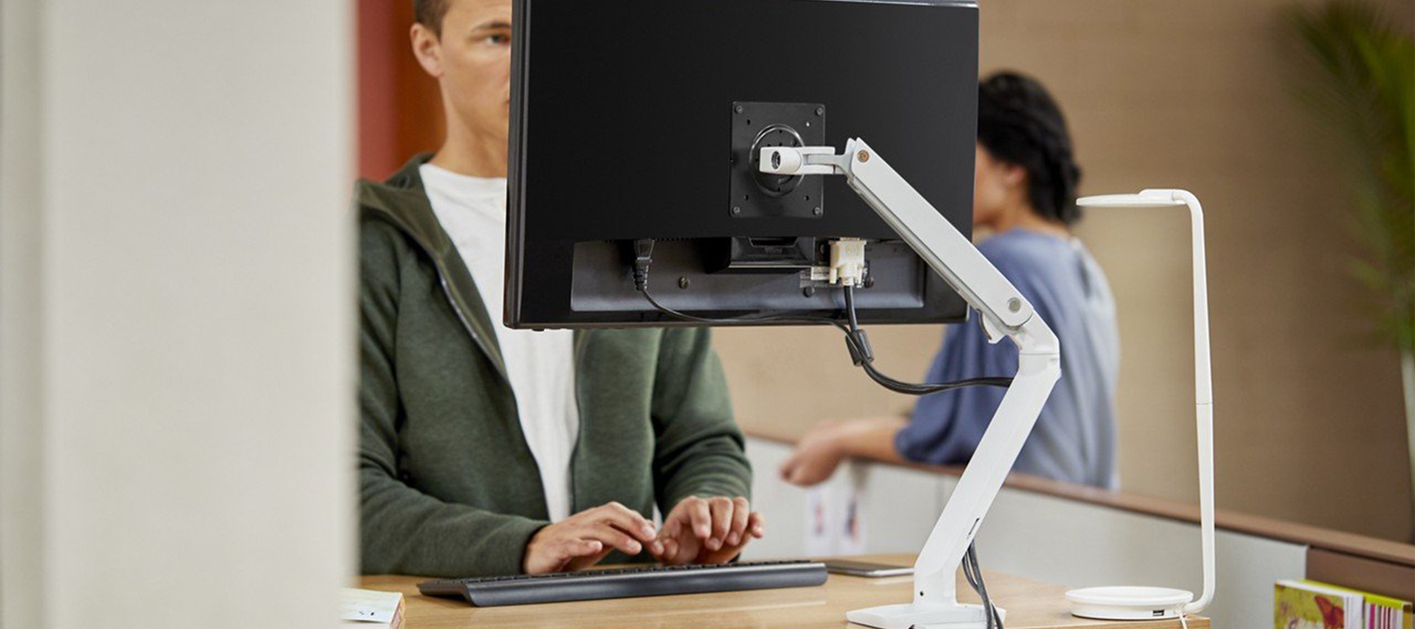 Haworth Ergotron monitor arms attached to a monitor  in an office