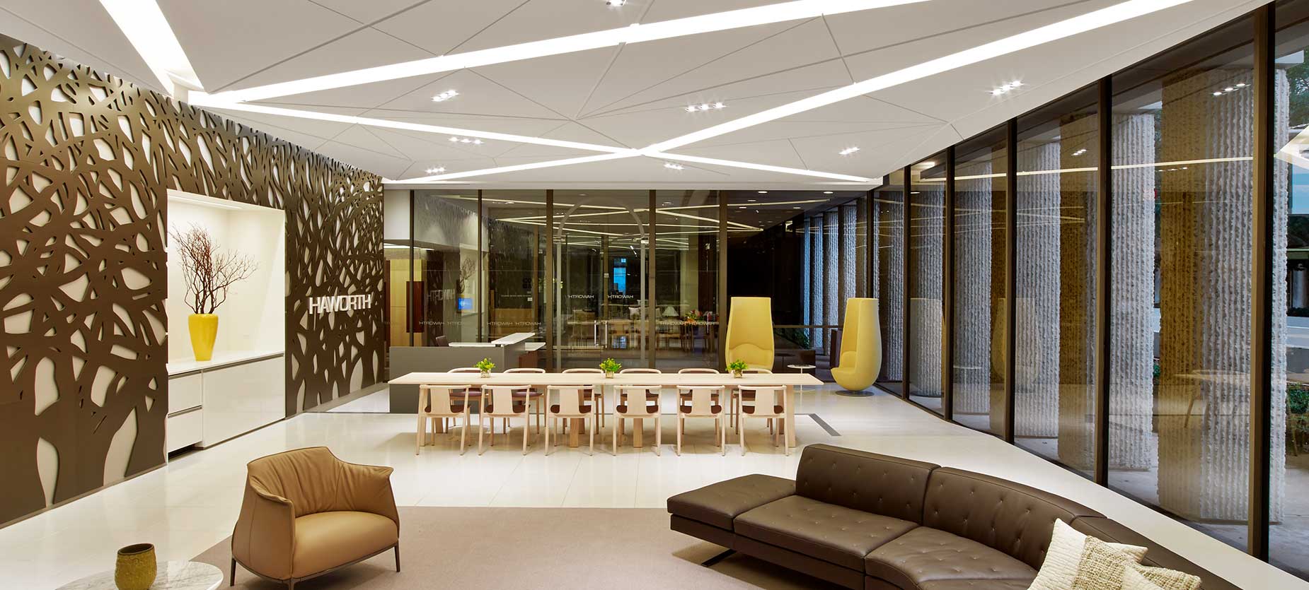 This Social Space demonstrates how various furniture settings can be combined to serve multiple functions efficiently on a floor plate. Not only does it serve as traditional reception seating due to It’s proximity to the main entry, the adjacent communal table create an activated meeting zone. The dimensional feature wall echoing the live oak trees at the exterior of the space add to the ambience.