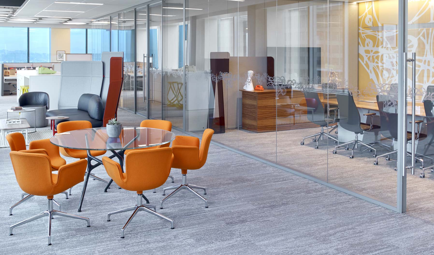 This area demonstrates how both traditional and informal meeting areas can be paired to support various types of collaboration. The use of glass, the ceiling plane, and shared views to the outside help these spaces feel connected.