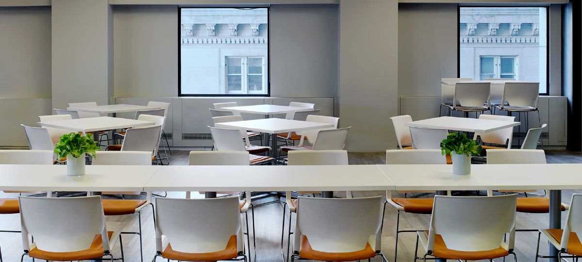 Adjacent to the commercial kitchen, this flexible space can host lunch or be rearranged for activity-based training.