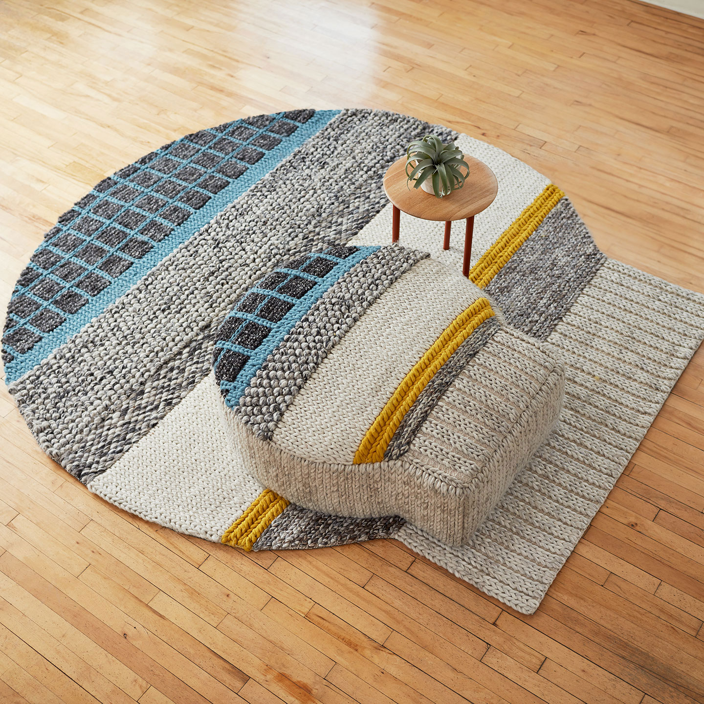 Haworth Mangas Original Rug in multiple colors and wool material and circular shape under ottoman in same shape and color with table on the rug also