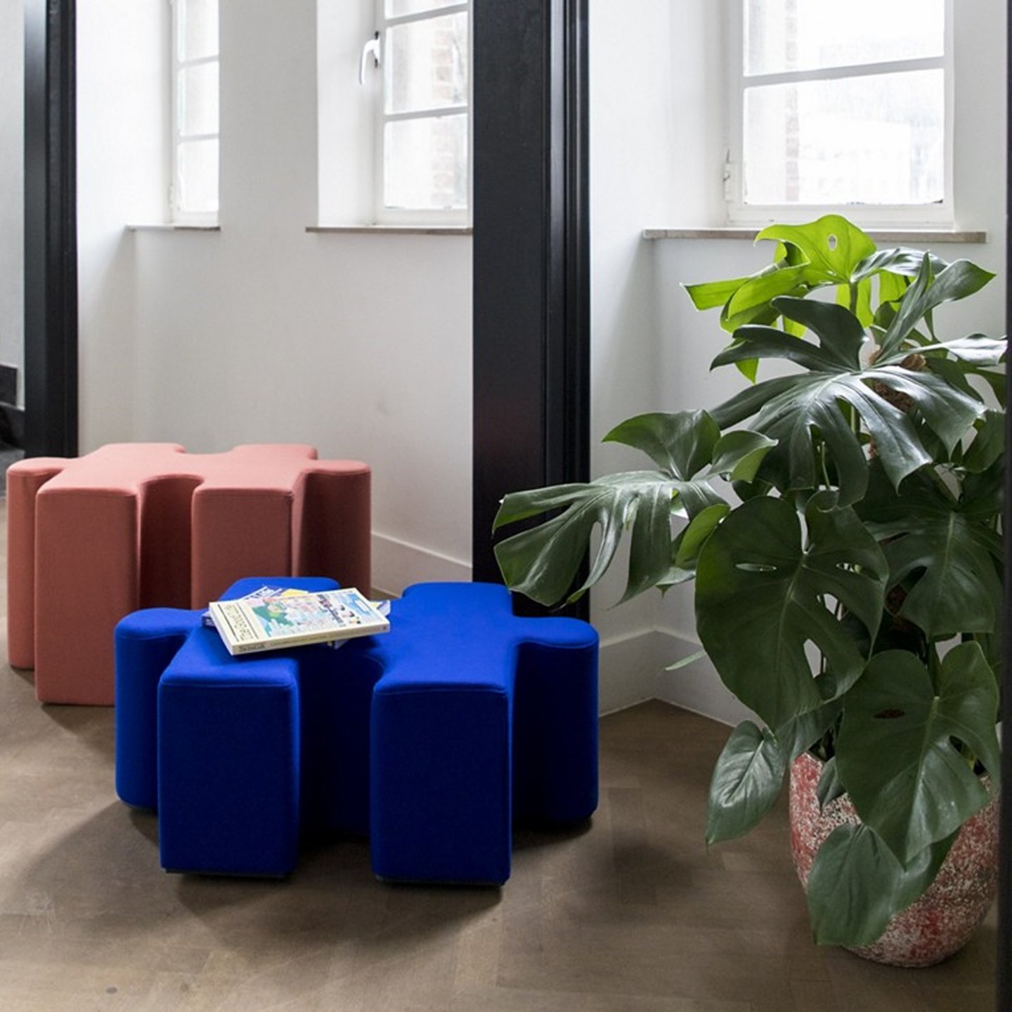 Haworth Buzzipuzzle poufs in pink and blue colors in a office corner space