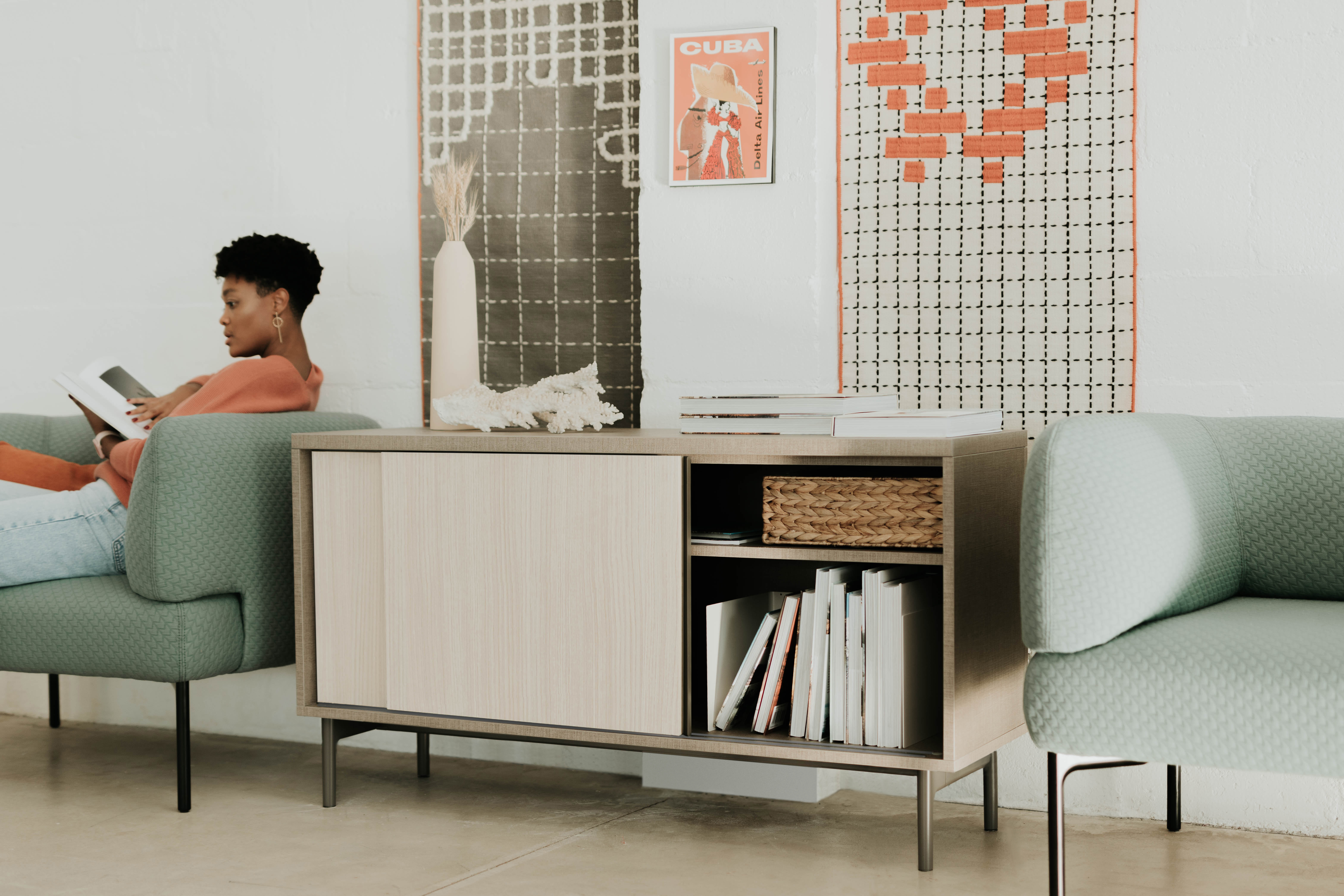 Be_Hold credenza with sliding cabinet doors over shelves.